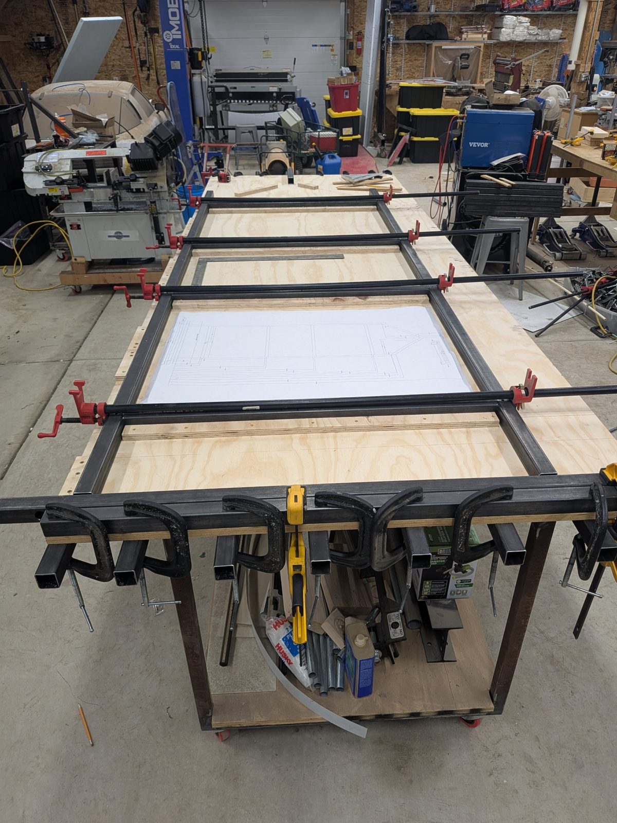 Steel frames being welded over the printed plan